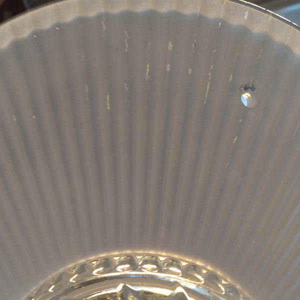 The semi-flush triple-beaded chain ceiling light fixture emerged with its earliest iterations in the 1920s through the 1940s. Triple-beaded chain fixtures of this period featured bold patterns and almost always had enameled finishes in pinks, blues, greens, whites, or bisque colors. The trend continued into the 1960s with less heavy-looking glass shades and silk-screened enameled finishes instead of the hand-painted enameled finish. Available at www.vintporium.com