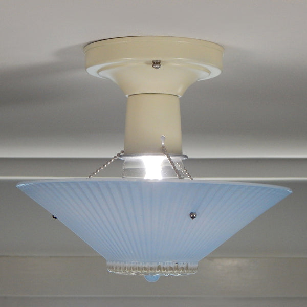 The semi-flush triple-beaded chain ceiling light fixture emerged with its earliest iterations in the 1920s through the 1940s. Triple-beaded chain fixtures of this period featured bold patterns and almost always had enameled finishes in pinks, blues, greens, whites, or bisque colors. The trend continued into the 1960s with less heavy-looking glass shades and silk-screened enameled finishes instead of the hand-painted enameled finish. Available at www.vintporium.com