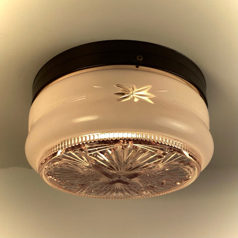 Vintage flush mount ceiling light with frosted glass shade and starburst cut glass diffuser illuminated