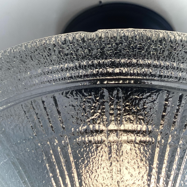 detailed rim view of vintage pressed glass ceiling light shade with minor age-appropriate wear