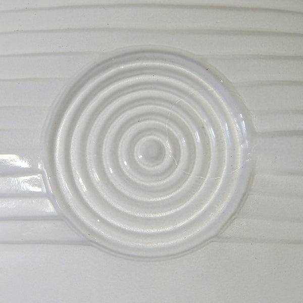 Close-up of stepped enameled glass shade showing Art Deco design lines and smooth satin nickel holder.