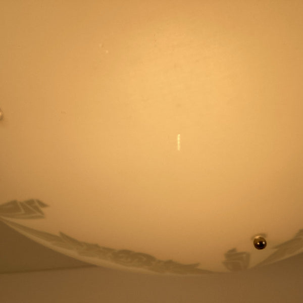 Surface detail of frosted enameled glass bowl on a 1950s semi-flush ceiling light