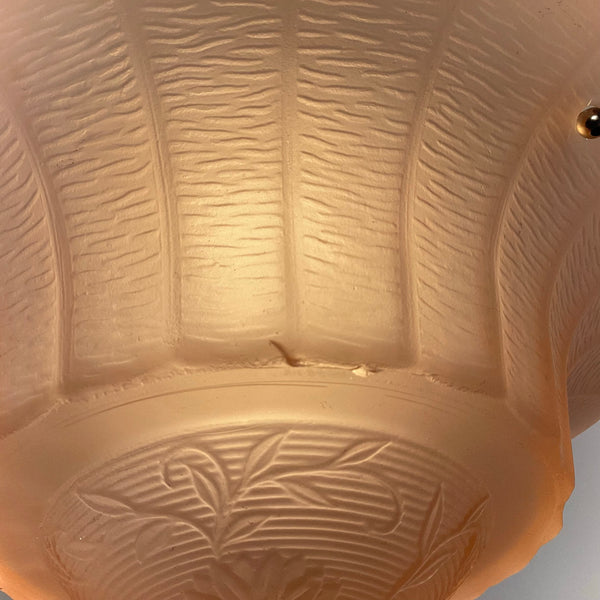 Close-up showing shallow surface flake on vintage 1930s peach glass shade