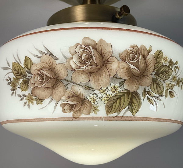 This semi-flush ceiling light features a vintage 1970s glass shade that combines hand-painted bands and a screen-printed floral motif. Screen printing is a technique widely used for applying designs and patterns onto various surfaces, including glass. In the 1970s, this method gained popularity due to its versatility and ability to produce high-quality, durable prints. Available at www.vintporium.com