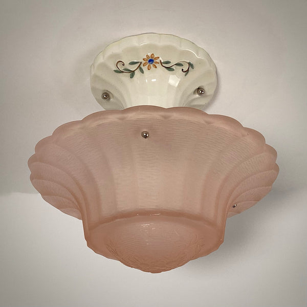 Peach pressed glass Art Deco ceiling fixture with floral porcelain canopy.