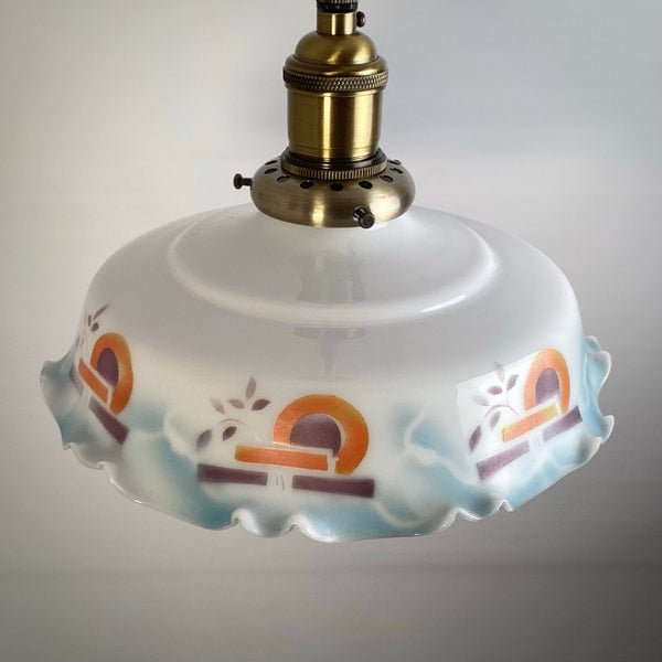 Side view of an antique-style ceiling lamp featuring a white opal glass shade with colorful geometric patterns.