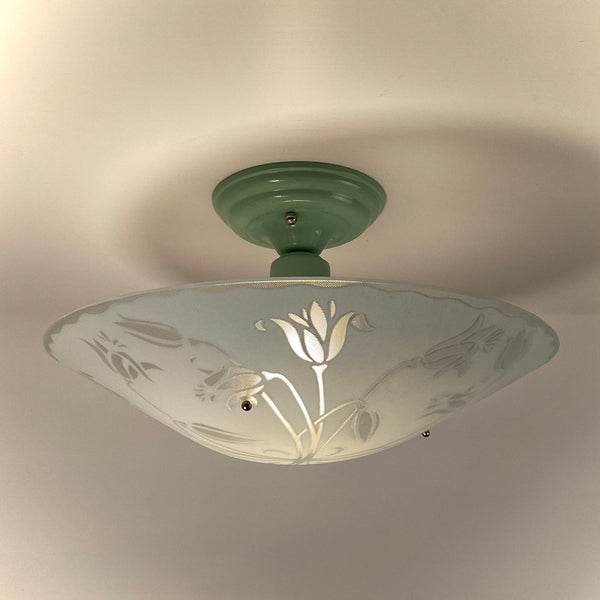 Mid-Century style ceiling light with a mint green porcelain-look base and detailed tulip floral glass shade.