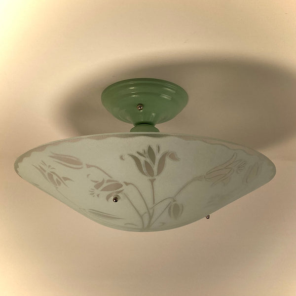 Retro 1950s style ceiling lamp with a sage green mount and etched floral frosted glass bowl.