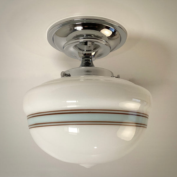 Art Deco semi-flush mount light fixture with polished chrome finish and striped glass shade, cool daylight.