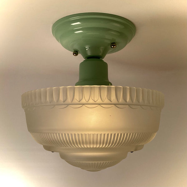 1930s–1940s semi-flush ceiling light side view while lit, showing ribbed frosted glass shade