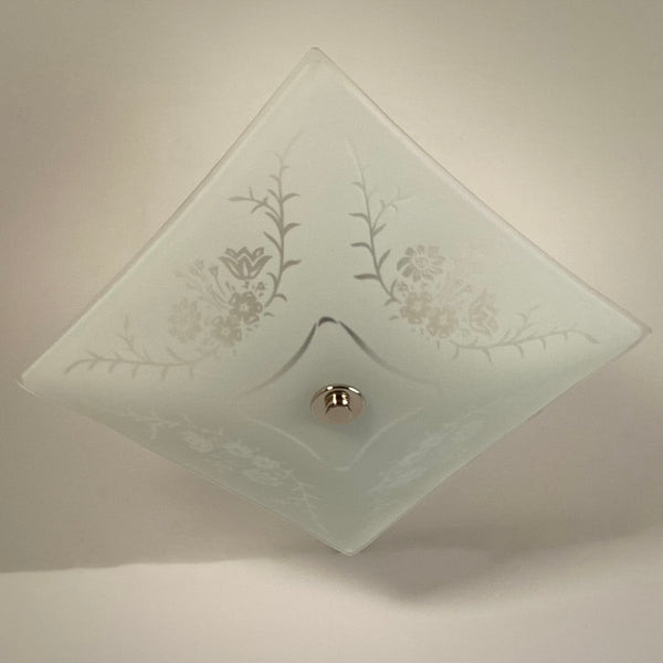 Close-up of square frosted glass ceiling light showing etched floral and botanical detail
