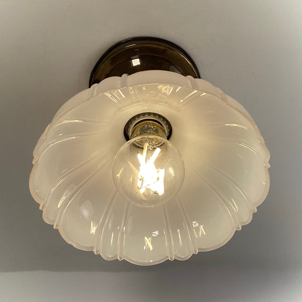 Antique brass flush mount ceiling light bottom view with scalloped glass