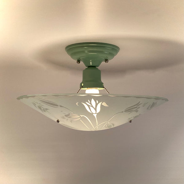 Side profile of a mint green semi-flush mount light showing the beaded chain suspension and illuminated bulb.