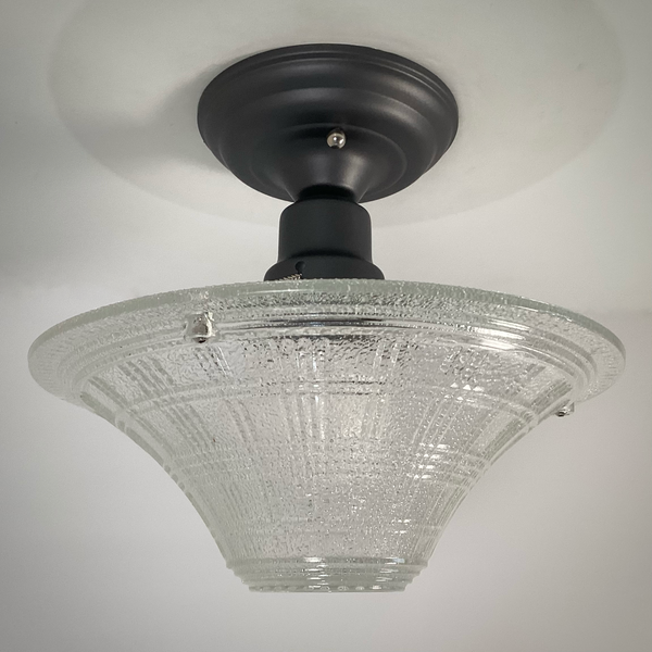 close-up view showing geometric texture on vintage pressed glass ceiling light shade