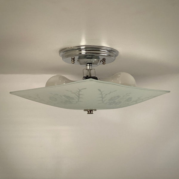 Interior view of vintage ceiling light showing dual bulb socket and mounting hardware