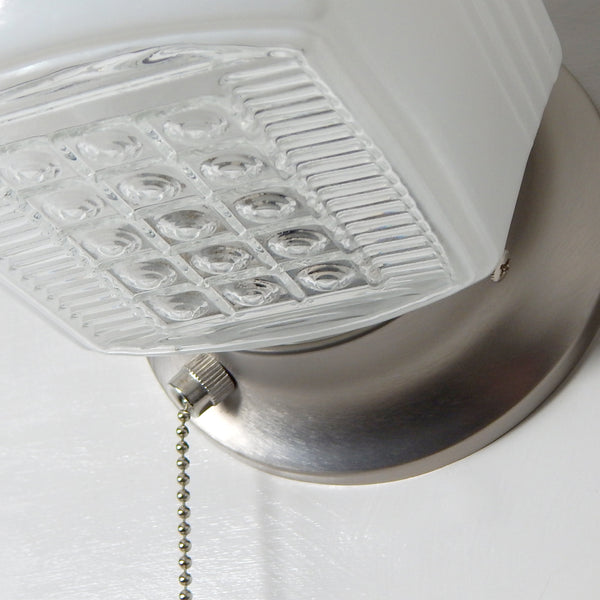 Vintage wall-mounted light fixture with pull chain, satin nickel base, and classic machine-age styling — Vintporium lighting.