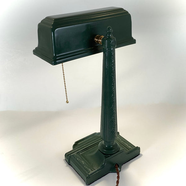 Antique Cast Iron Art Deco Bankers Lamp. This unique antique 1920s desk lamp, with its distinctive green enameled paint and brass highlights, is an outstanding piece. The fixture has been rewired, cleaned, and detailed for your convenience. Available at www.vintporium.com