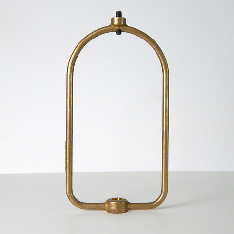 This harp is the most versatile center-post shade holder available on the market. It is designed to fit glass shades with either a 1/8 IPS center hole or a smaller 1/4-27 thread. The harp can be used for boudoir lamps or ceiling center-post light fixtures. The harp supports the shade and usually mounts under the socket and socket cup to the ceiling canopy or lamp base. The harp is unfinished brass. Available at www.vintporium