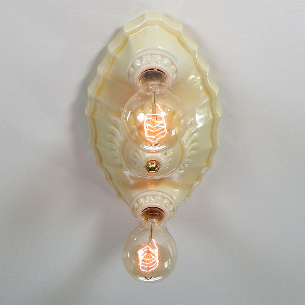 This beautiful antique ceiling light fixture is made of uranium glass glazed porcelain and features a classic Art Deco design. The fixture has been restored and features new wiring, sockets, etc. It has been cleaned and detailed and is ready to install. Available at www.vintporium.com