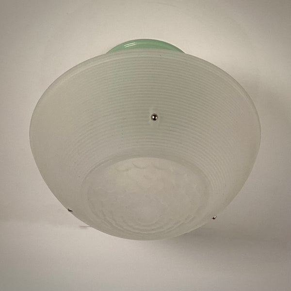 Ribbed frosted glass shade with scalloped bottom pattern on jadeite-green ceiling fixture
