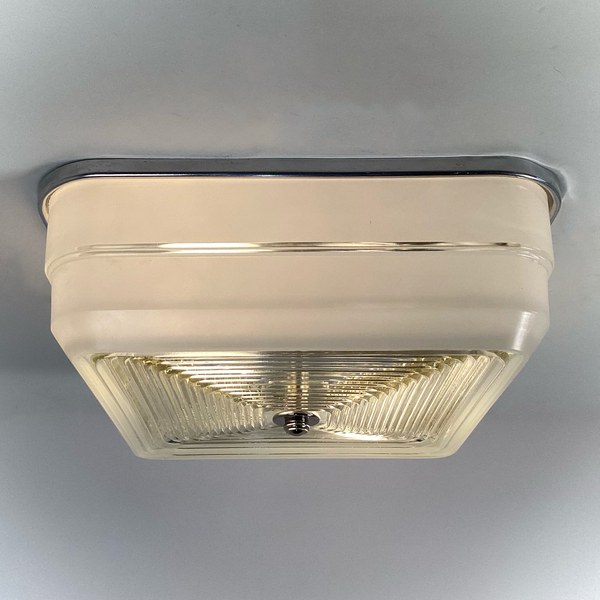 Mid-century square ceiling light with aluminum fixture base and frosted glass sides, partial illuminated view — Vintporium