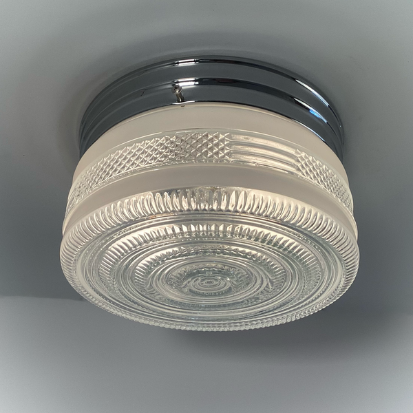 Vintage post-war flush mount ceiling light with clear pressed glass shade and chrome base. 