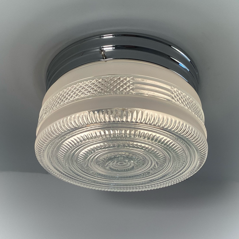Vintage post-war flush mount ceiling light with clear pressed glass shade and chrome base. 