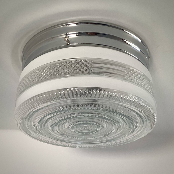 Vintage post-war flush mount ceiling light with clear pressed glass shade and chrome base. 