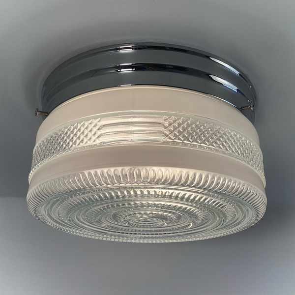Vintage post-war flush mount ceiling light with clear pressed glass shade and chrome base. 