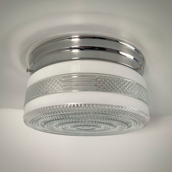 Vintage post-war flush mount ceiling light with clear pressed glass shade and chrome base. 