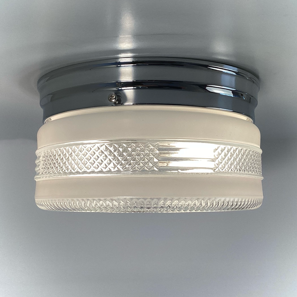 Vintage post-war flush mount ceiling light with clear pressed glass shade and chrome base. 