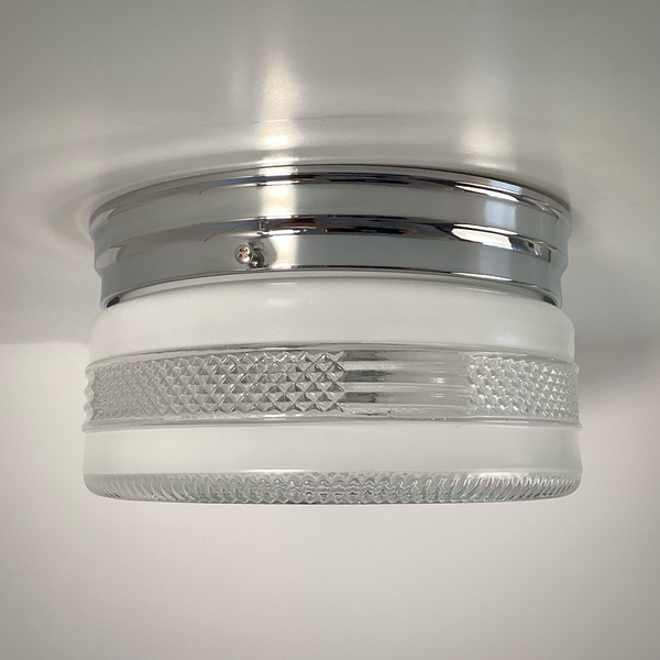 Vintage post-war flush mount ceiling light with clear pressed glass shade and chrome base. 