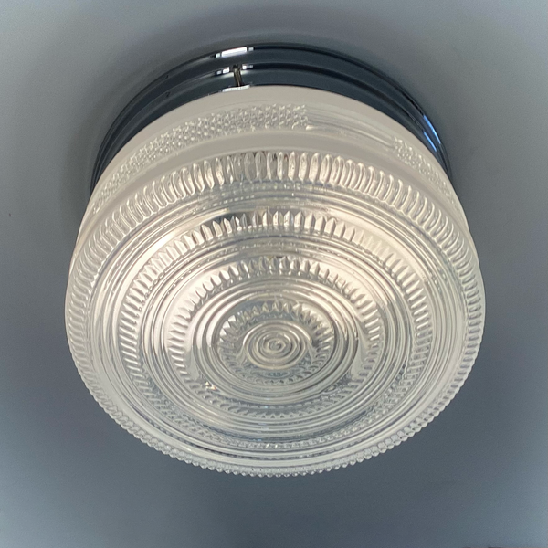 Vintage post-war flush mount ceiling light with clear pressed glass shade and chrome base. 