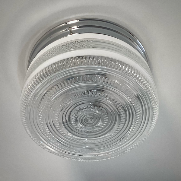 Vintage post-war flush mount ceiling light with clear pressed glass shade and chrome base. 