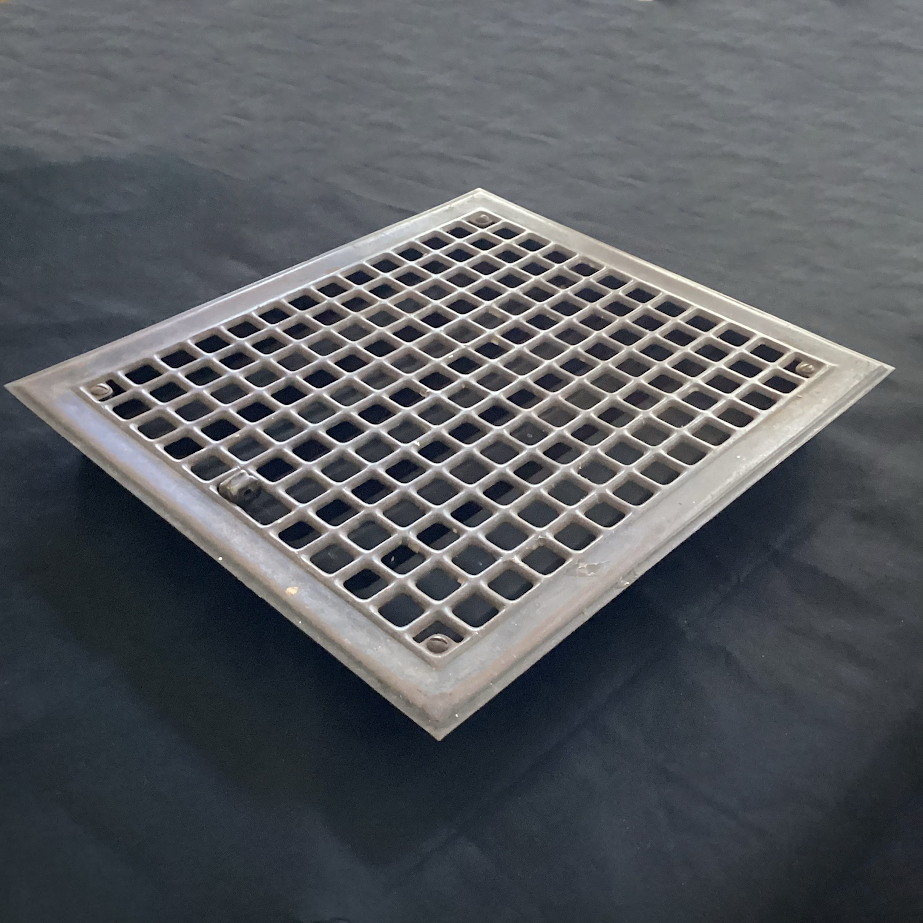 Antique Steel Hear Floor Register. Add a touch of industrial charm and historic character to your space with this antique 1910s heat register, featuring a classic square grid design and working damper lever. Available at www.vintporium.com