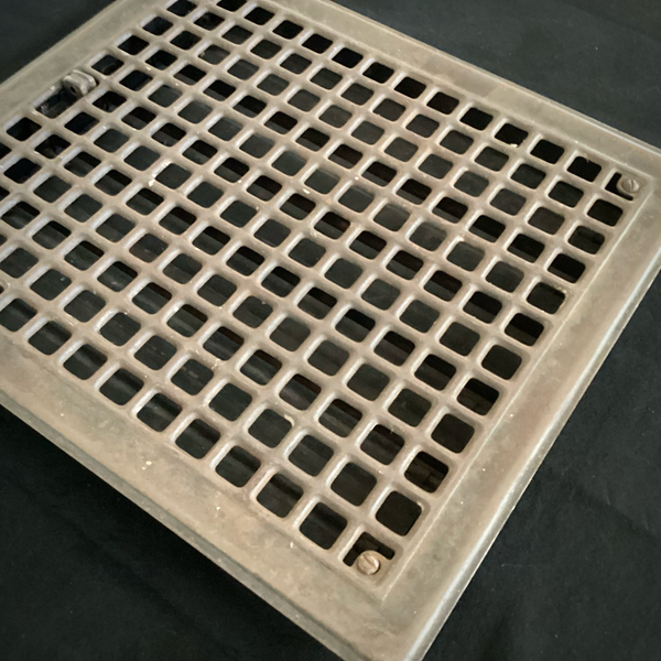 Antique Steel Hear Floor Register. Add a touch of industrial charm and historic character to your space with this antique 1910s heat register, featuring a classic square grid design and working damper lever. Available at www.vintporium.com