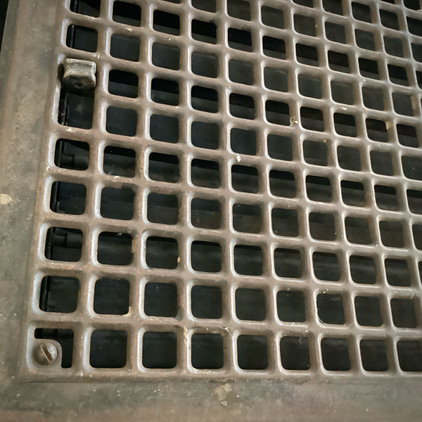 Antique Steel Hear Floor Register. Add a touch of industrial charm and historic character to your space with this antique 1910s heat register, featuring a classic square grid design and working damper lever. Available at www.vintporium.com