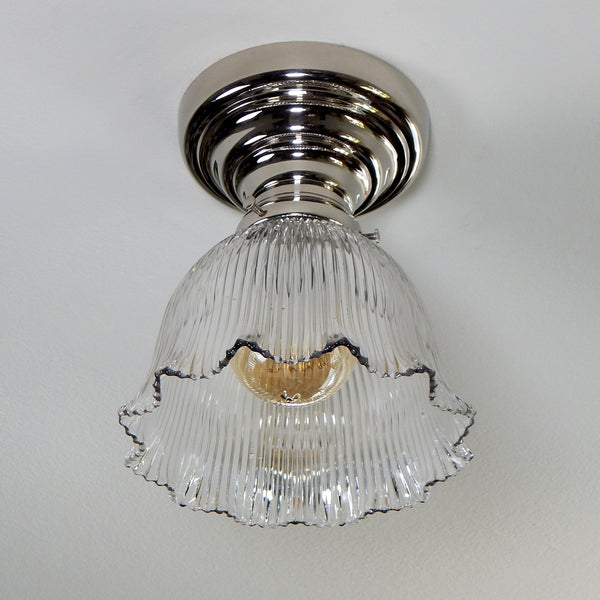 The antique semi-flush ceiling light features a Holophane glass shade and a thick polished nickel-plated ceiling light has been restored, detailed, cleaned, and is ready to install for your convenience. Available at www.vintporium.com