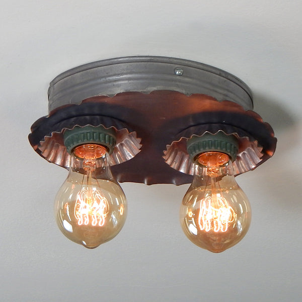 A vintage tin flush mount ceiling light that screams Americana. The light has been renovated with new sockets and wiring. The fixture has been cleaned and includes installation hardware making it easy and convenient to install. Available at www.vintporium.com