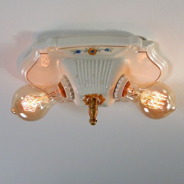 The vintage 1920's porcelain light fixture has been restored and features new wiring and sockets, etc. The fixture has been cleaned, detailed, and ready to install. Available at www.vintporium.com