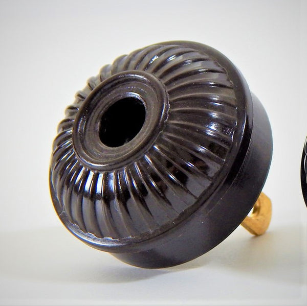 Early electric replica embossed ribbed motif bakelite plug. The plug features an insulator and polarized prongs.  Available at www.vintporium.com